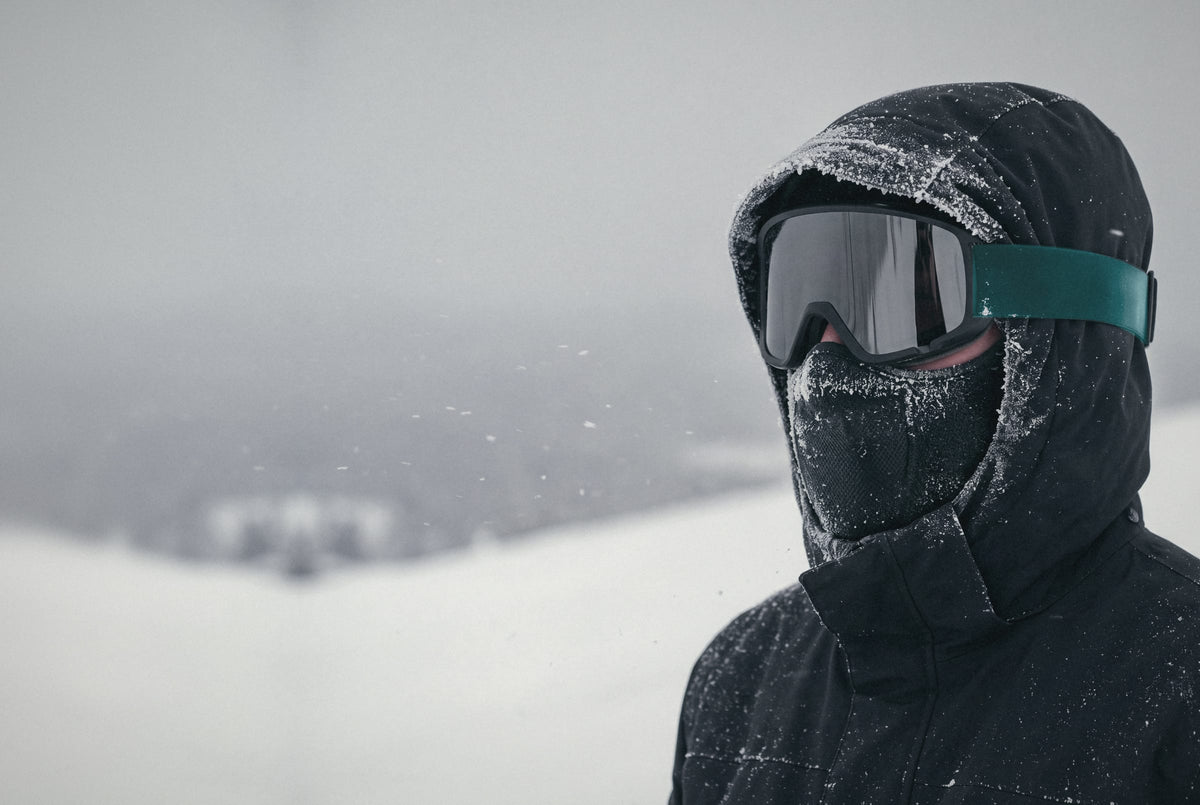 Frost on the hood and goggles, the OXYFIT Thermal Face Guard pulled up over the nose on a snowy mountain