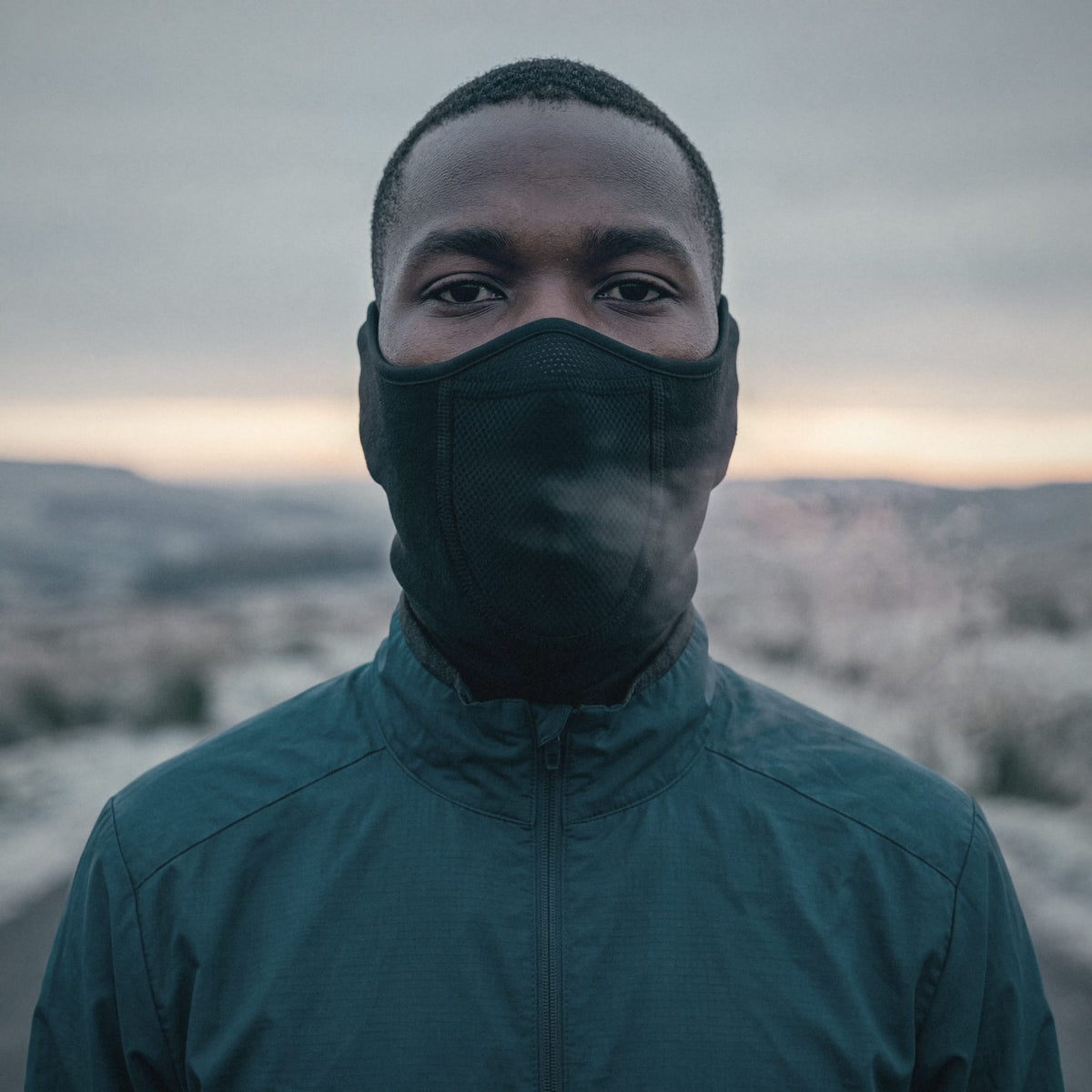 Runner at dawn wearing the Face Guard, breath vapour in the cold air