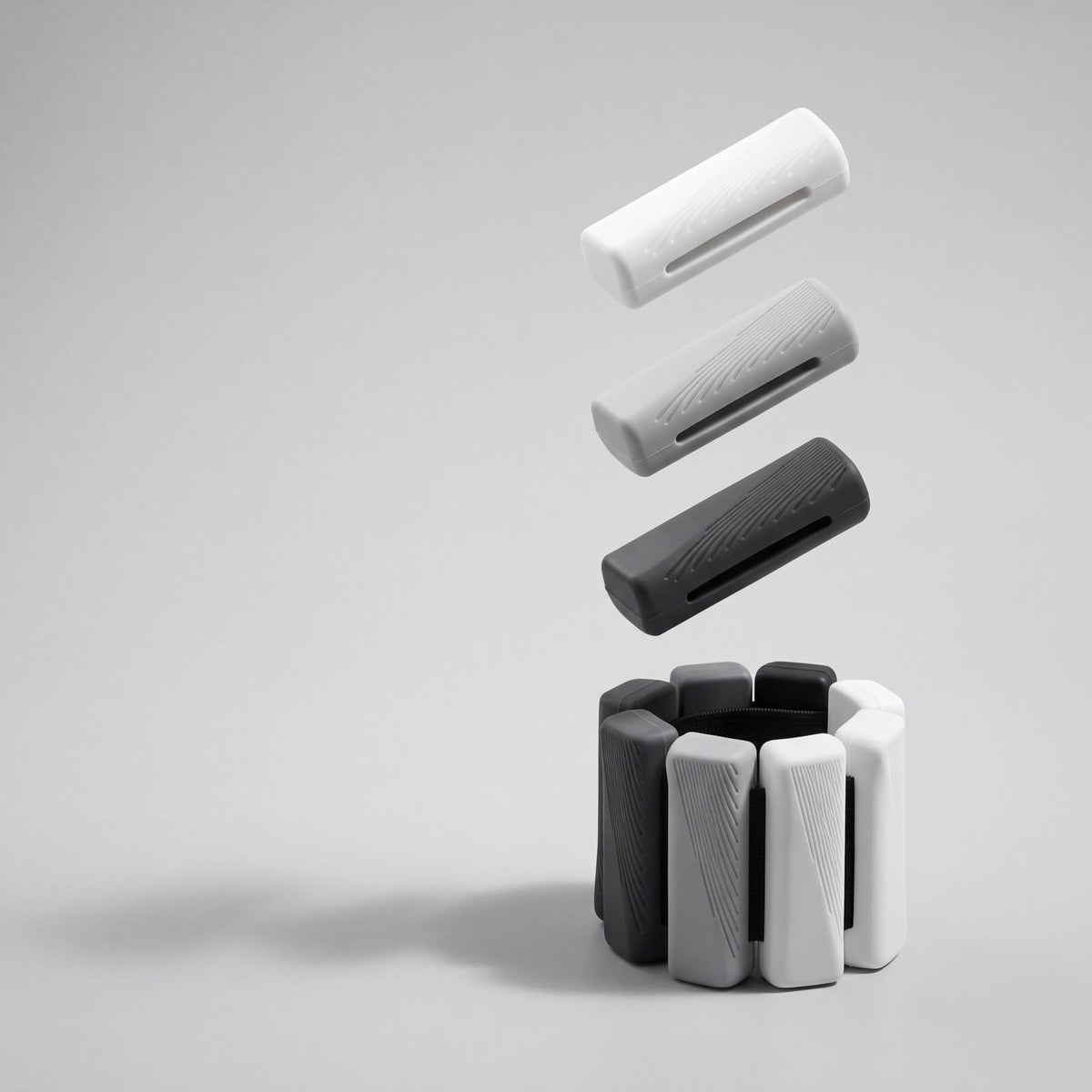 Exploded view: three silicone bars lifted above a strap of Slate Fade bars